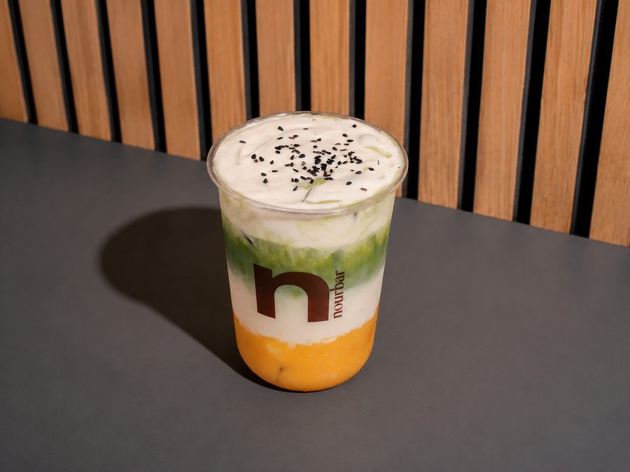 A layered Nourbar drink on a table